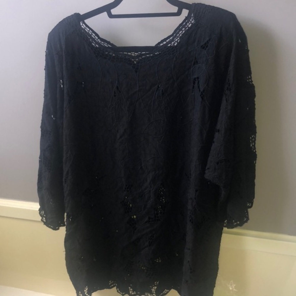 Beautiful black blouse with three-quarter sleeve scoop neck has cut out‎ areas